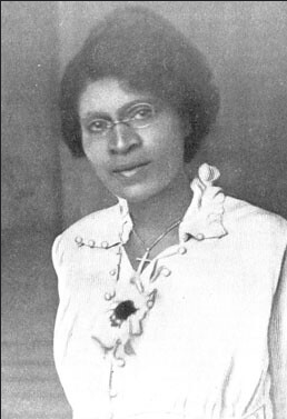 Dr. Charlotte Hawkins Brown standing posed, head tilted slightly left