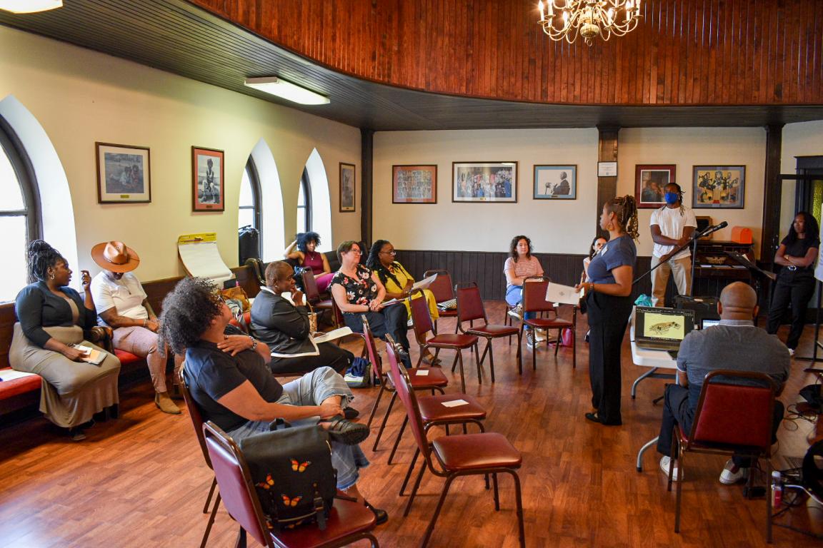 Community Members siting in listening Session in church