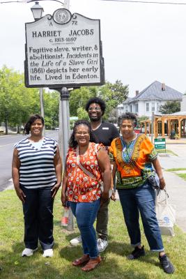 Teachers standing under a NC highway marker