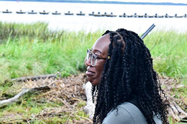 Women standing with shoreline in background