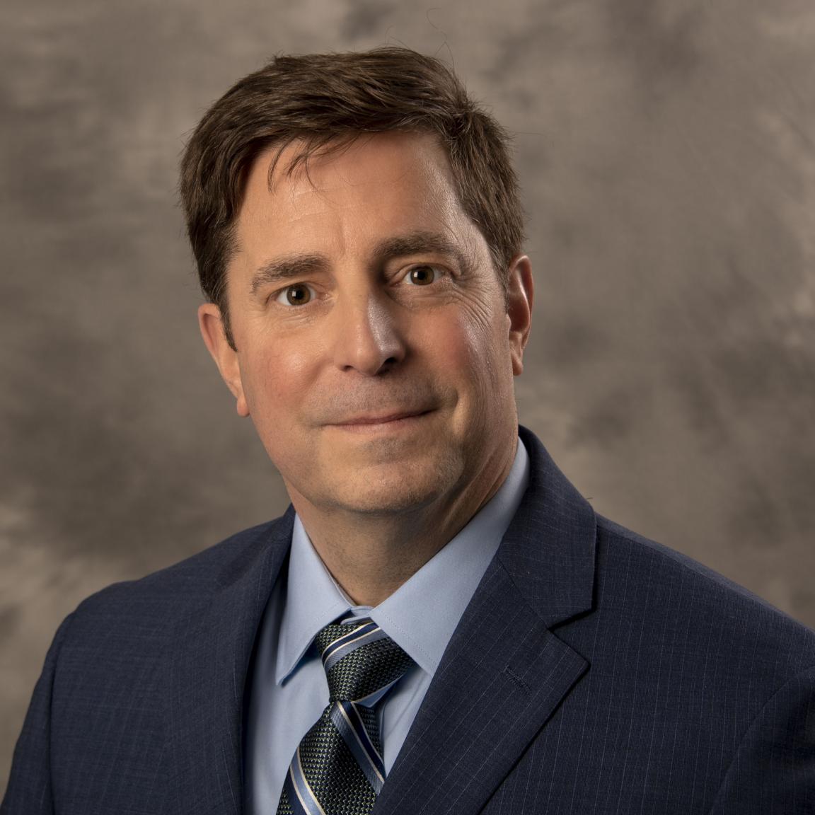 Chris Egan, NC ABLE Board member, in a suit and tie