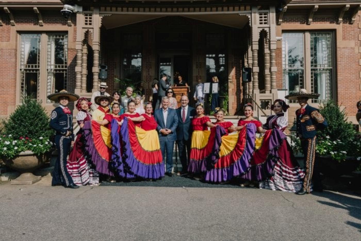 Governor Josh Stein and Secretary Gabe Esparza pose for a photo with dancers at the 2026 Hispanic and Latino Heritage Month event