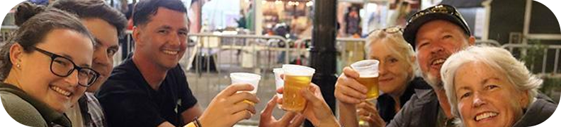Group of people toasting with cups of beer