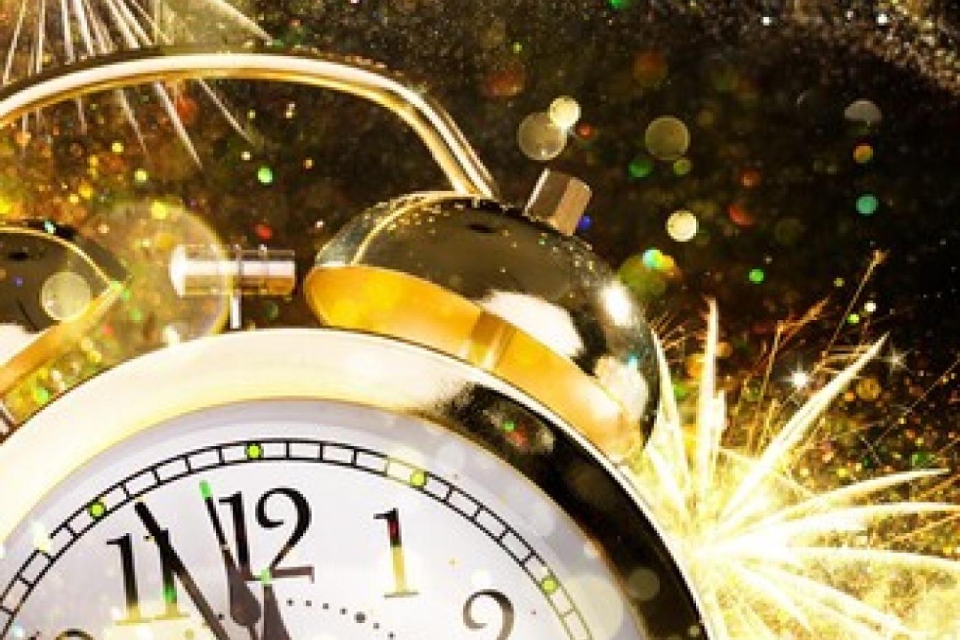Clock showing 11:55 p.m. time with fireworks