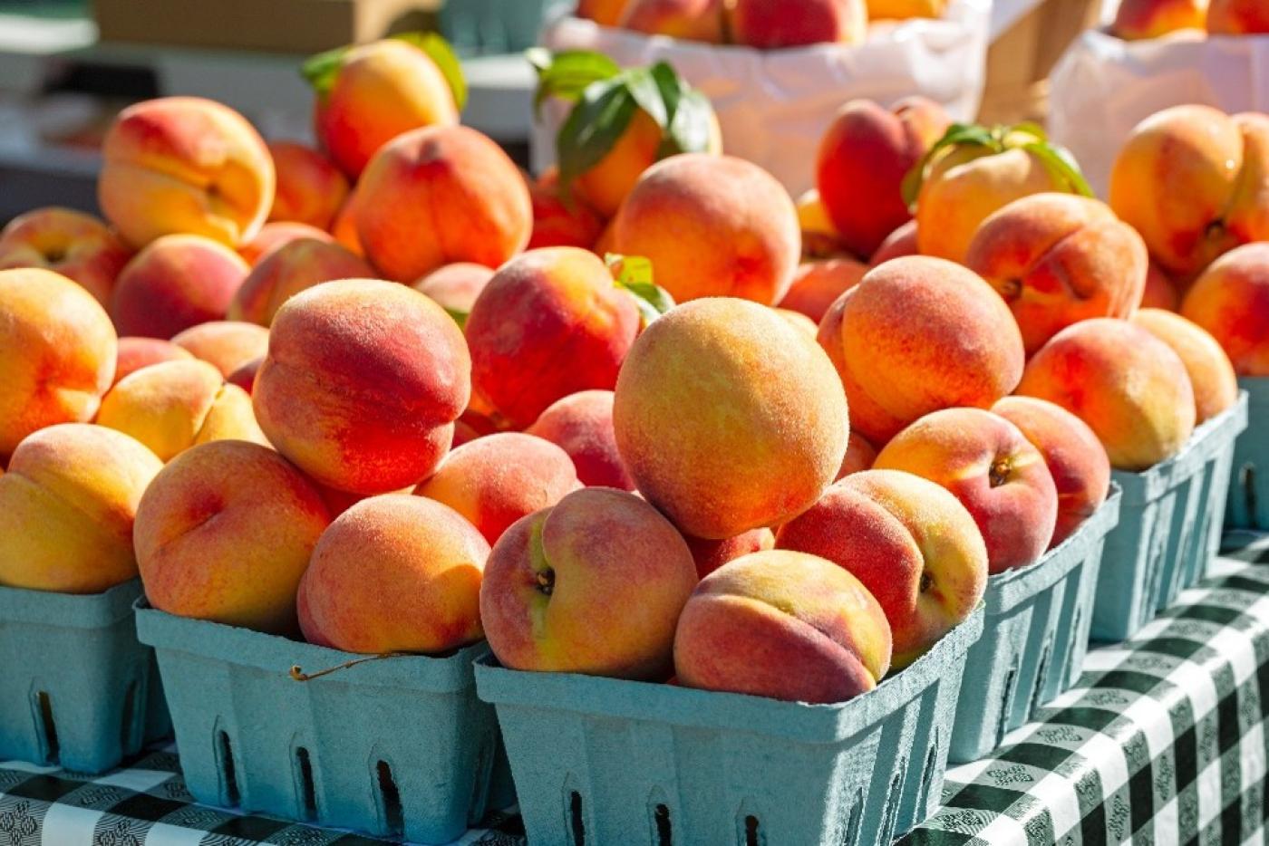 peaches in green containers for sale