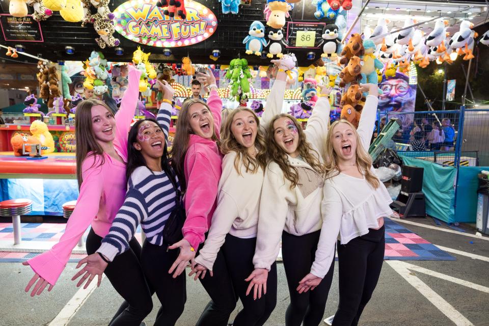 Group of Girls in front of a Carnival Game