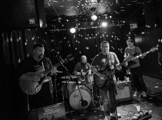 Group of individuals playing instruments B&W