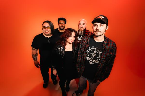 Group of people in all black looking at camera
