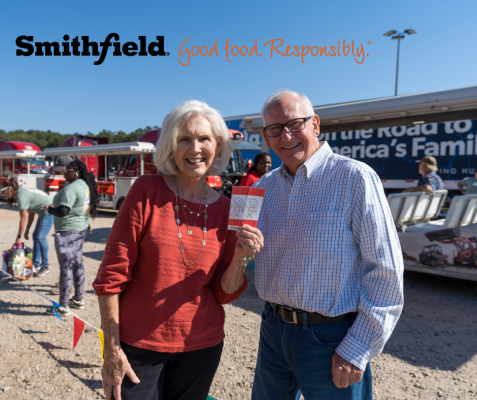 Couple holding cans and tickets