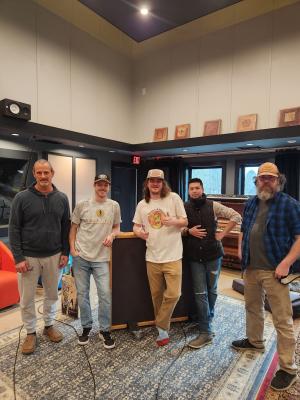 Five men standing in the lobby posing