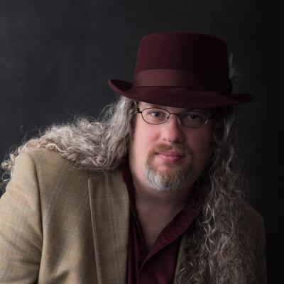 Man with long hair and a hat 
