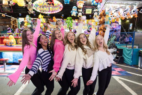Group of Girls in front of a Carnival Game