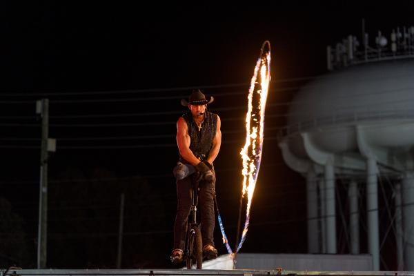 Cowboy on a unicycle with a fire lasso.