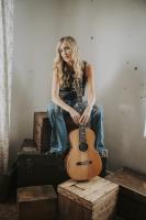 Lady Sitting on Crates with Guitar