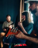 Three guys playing instruments