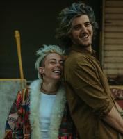 Lady leaning against the back of a Gentleman