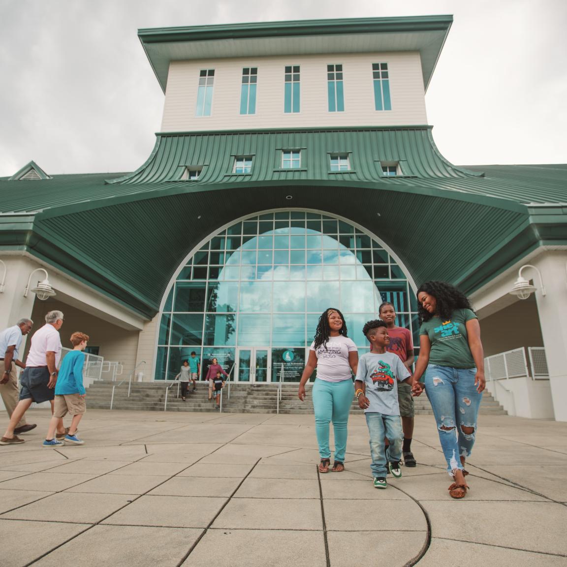 People walking in and out of a museum