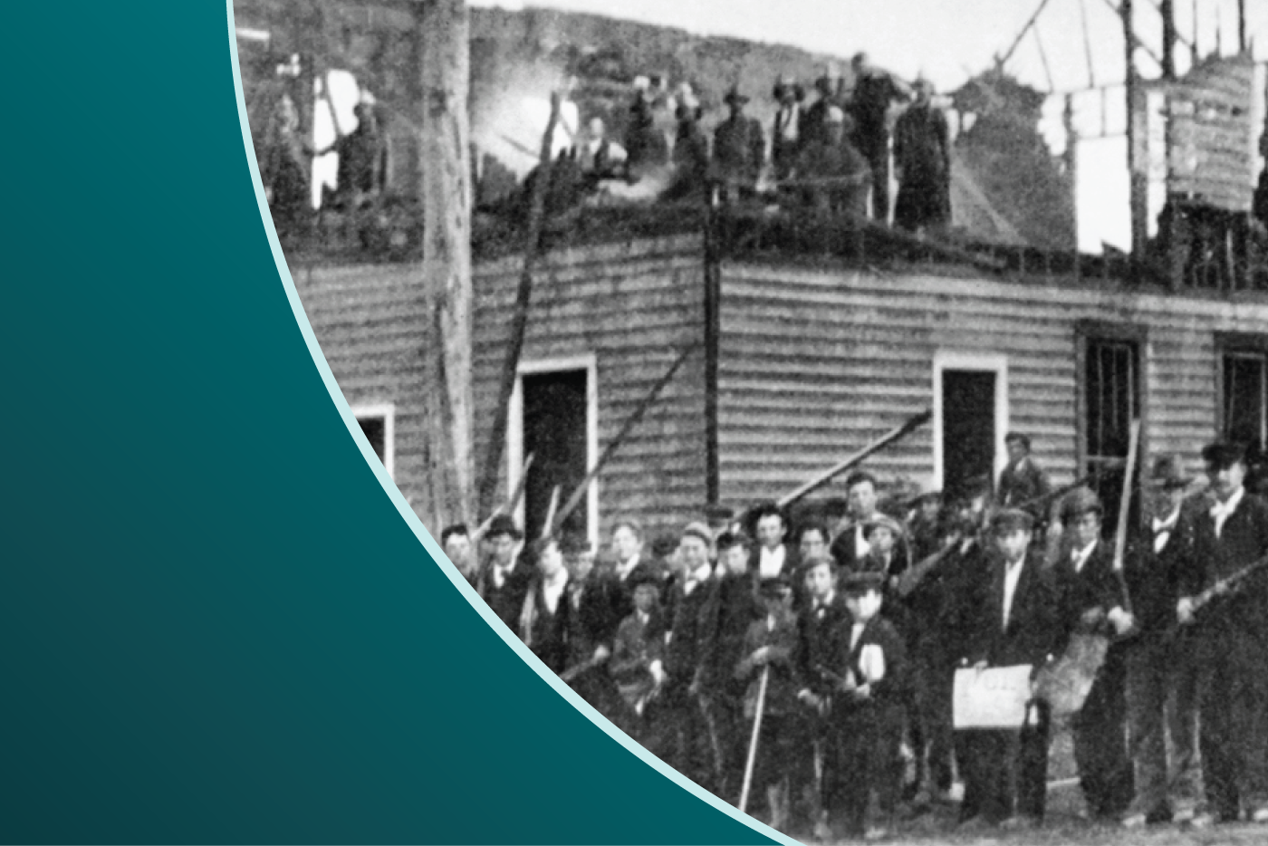 Men with guns outside a demolished building