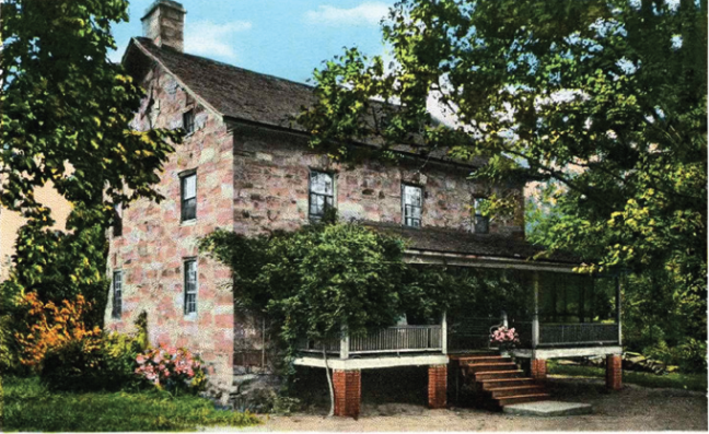 brick house with many trees around it