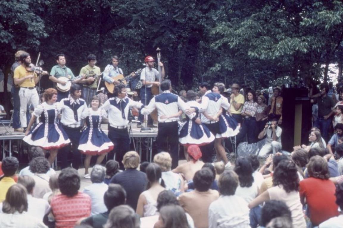 dancers on stage in front of a large crowd