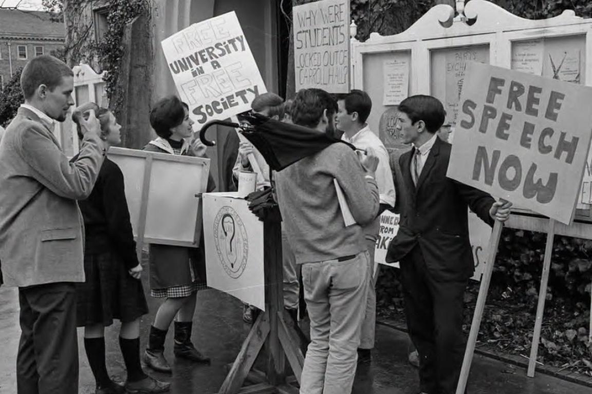 people standing in group holding protest signs
