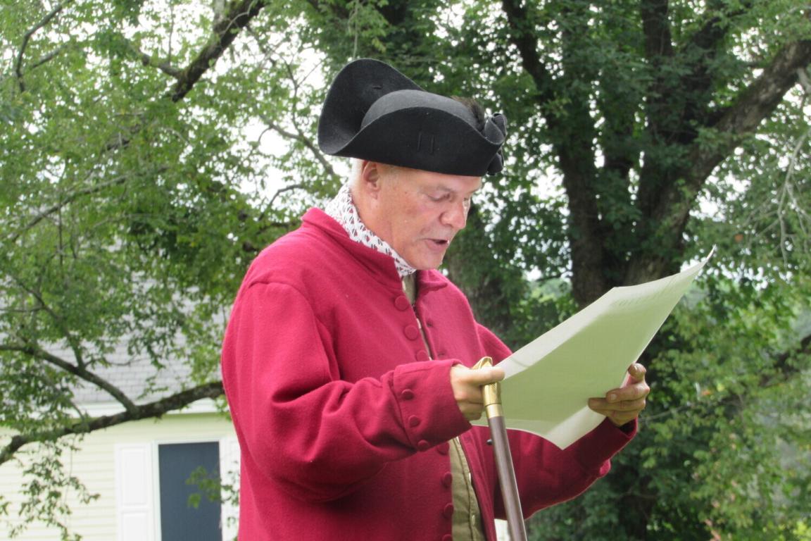 man in historical costume reading a paper