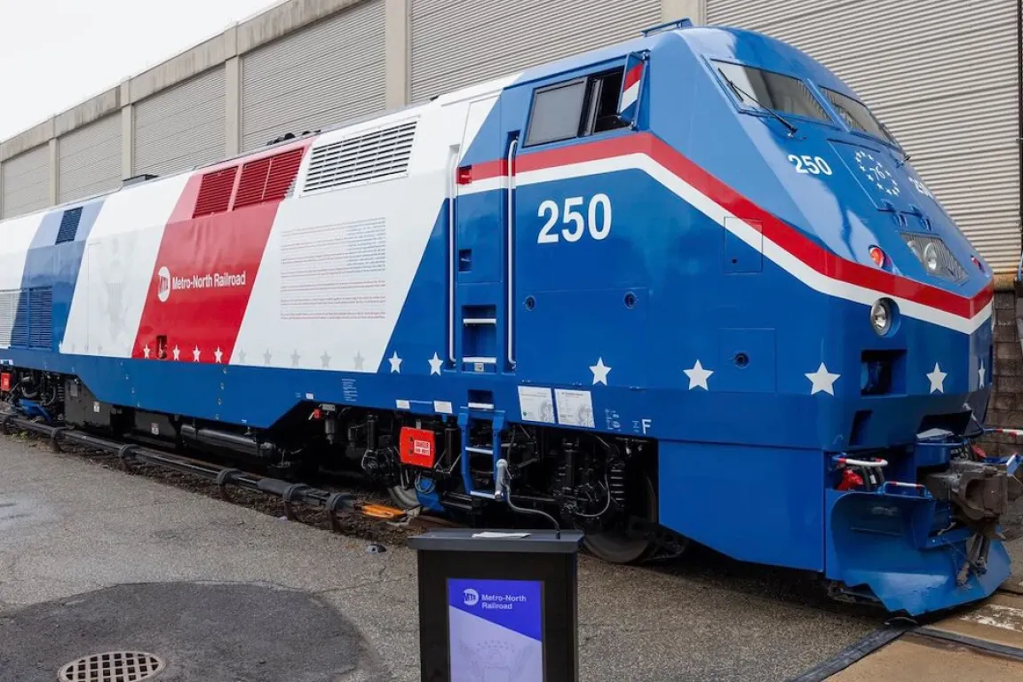 train painted red, white, and blue, with "250" near the front and white stars