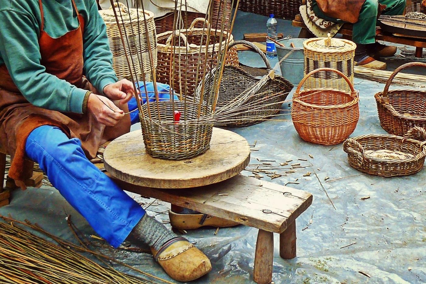 A person weaving a basket.