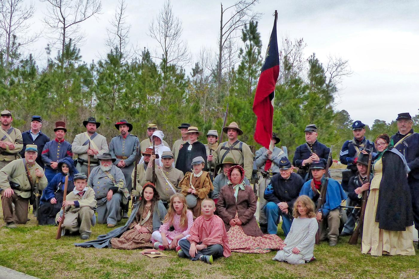 A lineup of historical interpreters dressed in Revolution era attire.