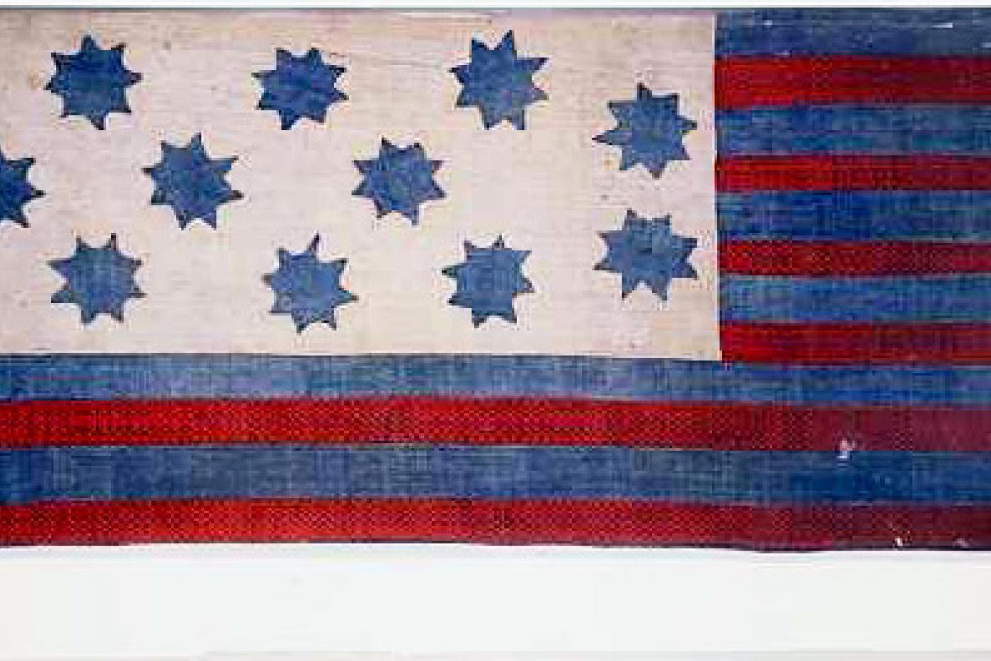 Red and blue stripped flag with blue stars on a white background