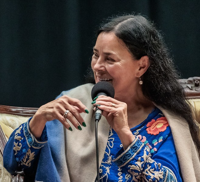 women sitting and speaking into a microphone