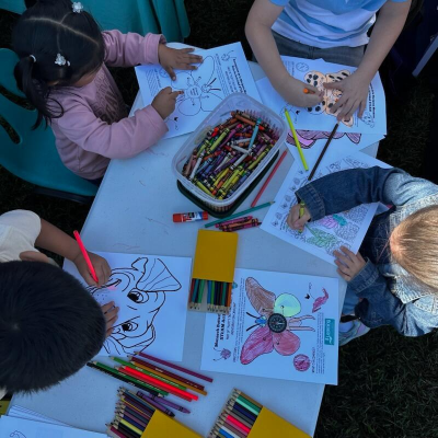 children coloring at a table