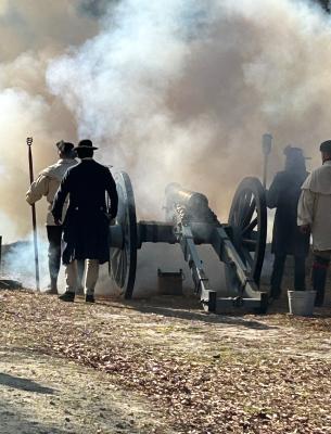 Men shooting a cannon