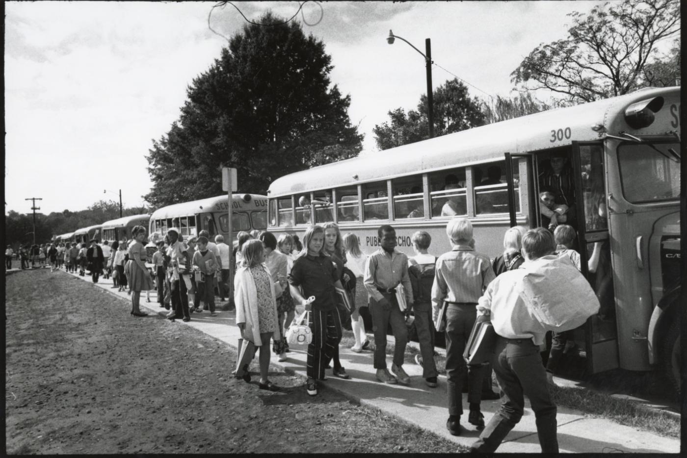 children entering school busses 