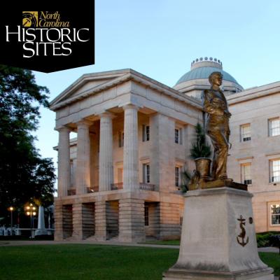 statue in the foreground and neo-classical style building in the background