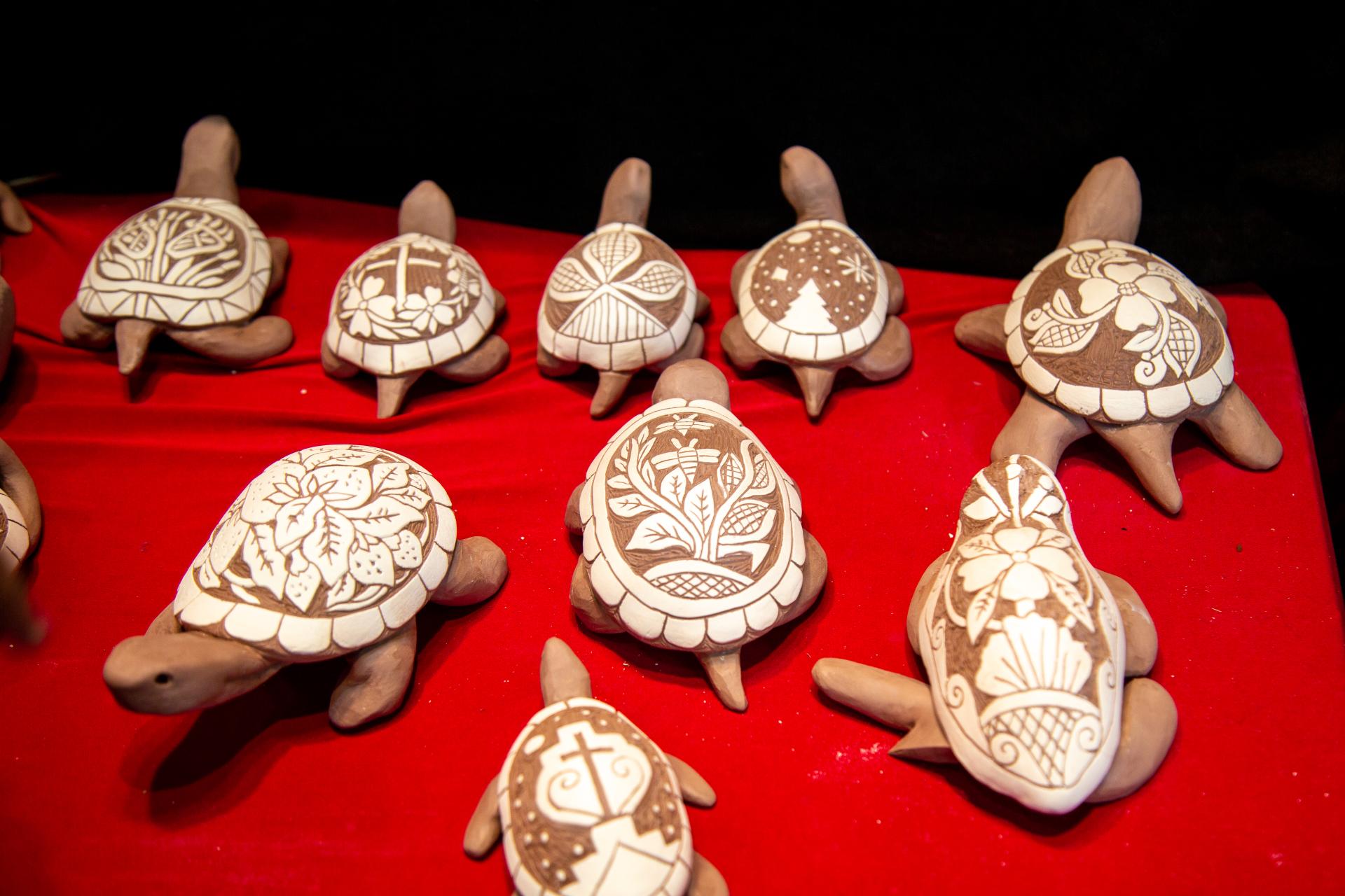 A display of 9 ceramic turtles by Senora Lynch with ornately decorated shells