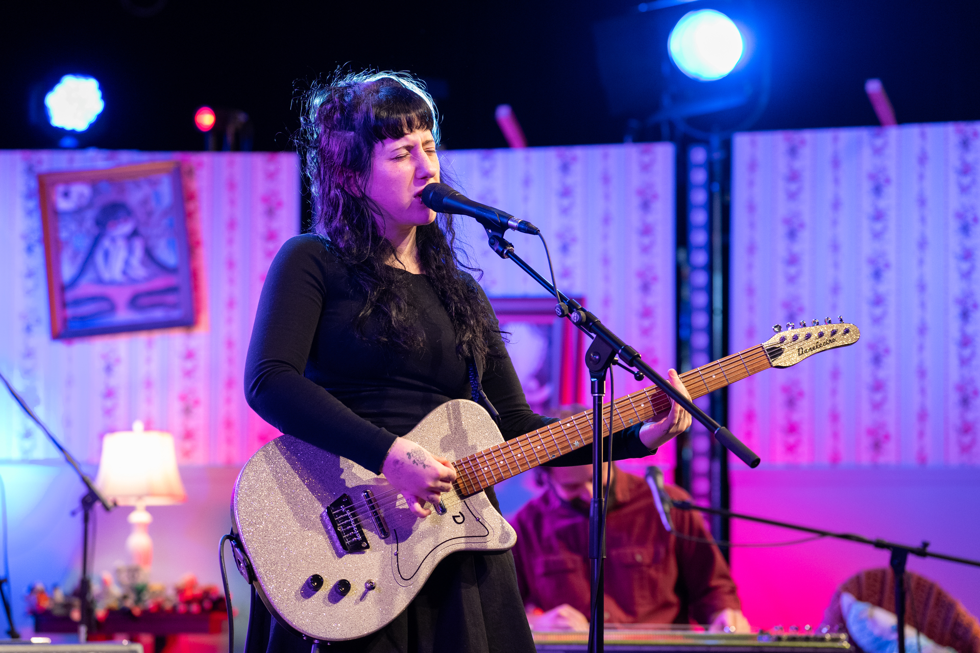 Wednesday performs on a set designed to look like a teenager's bedroom