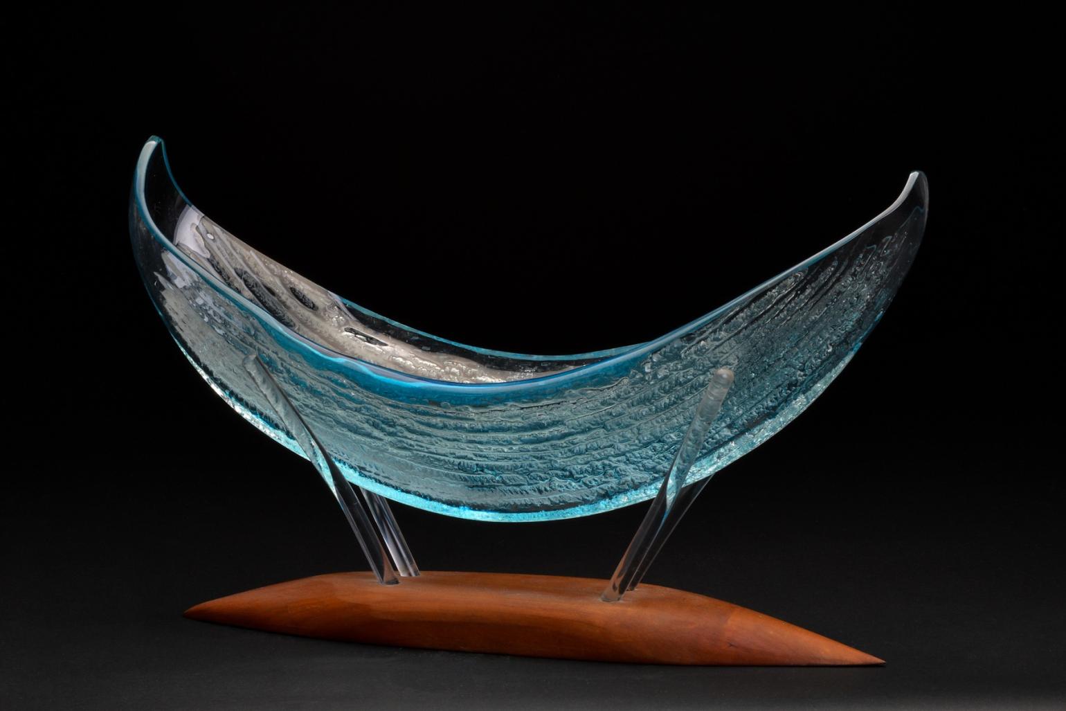 Judson Guérard glass work from his Bounty series - a translucent canoe shaped vessel in translucent blue