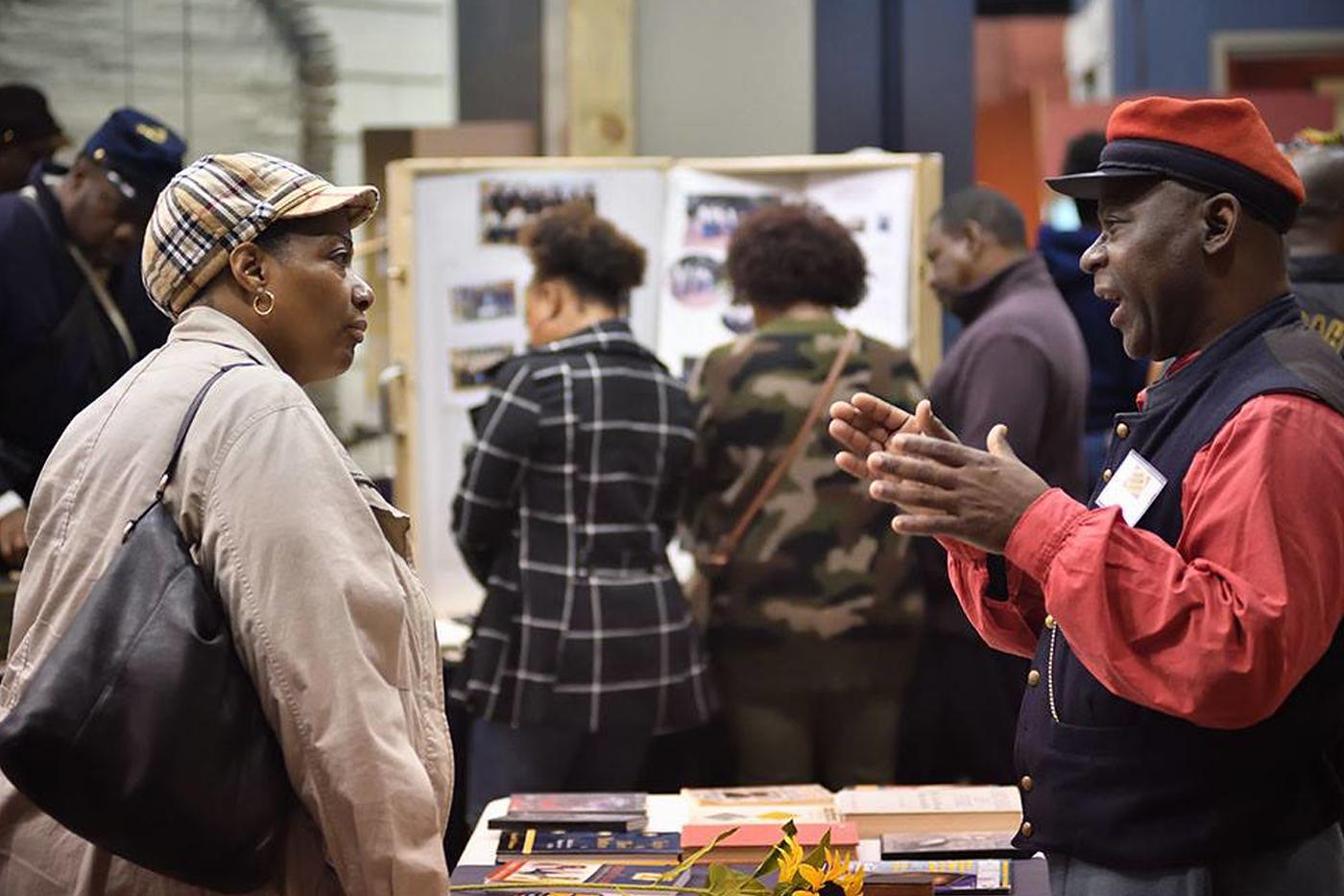 Volunteer speaking with a visitor at the 19th Annual AACC 2020. Photo by Eric Blevins, courtesy of DNCR