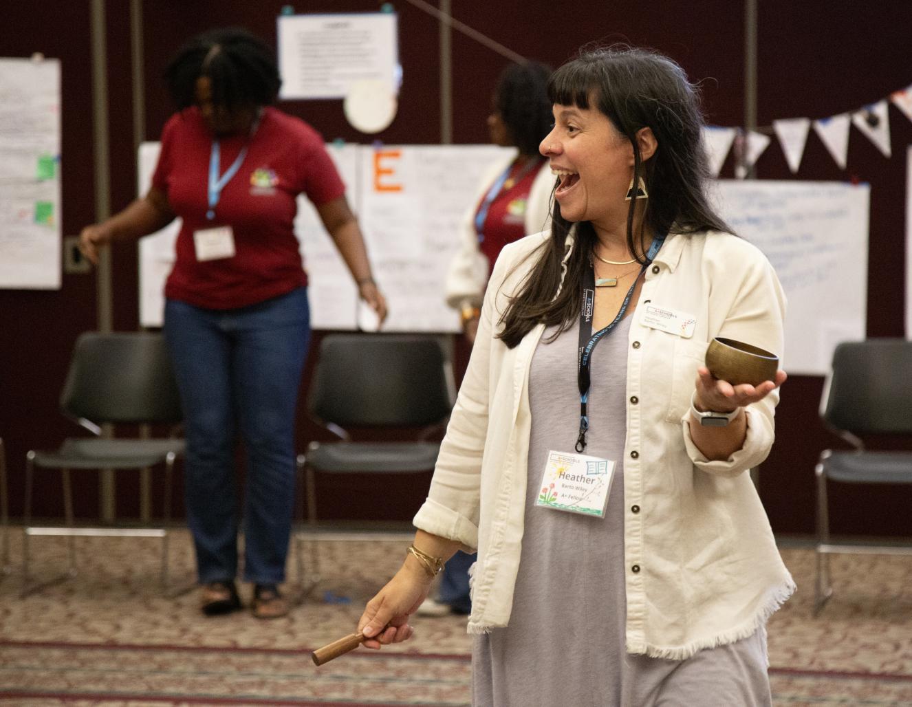 A teacher smiling and engaged in an A+ Schools summer professional development training
