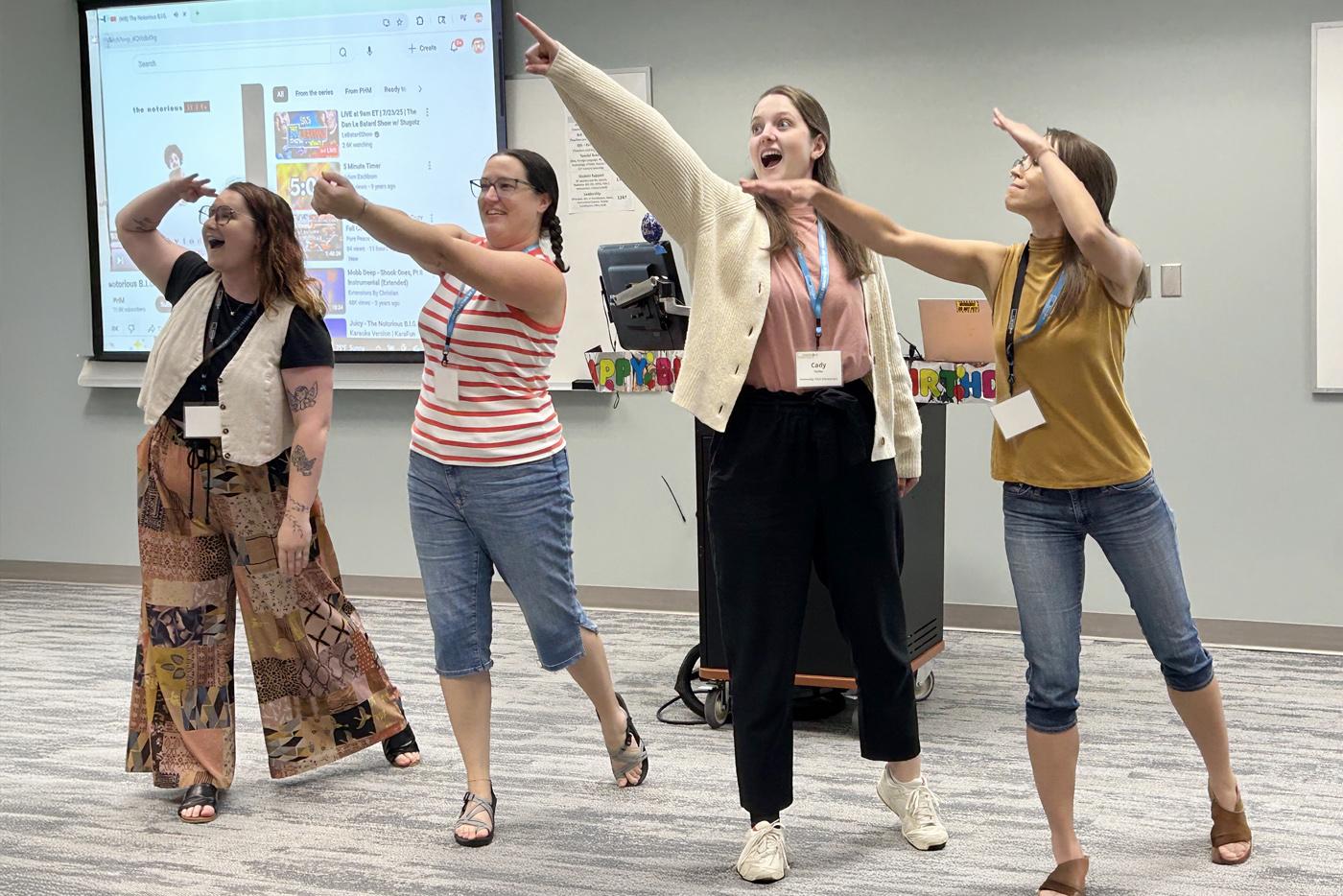Teachers at summer professional development pointing up at the sky. Photo by Sara Ridings