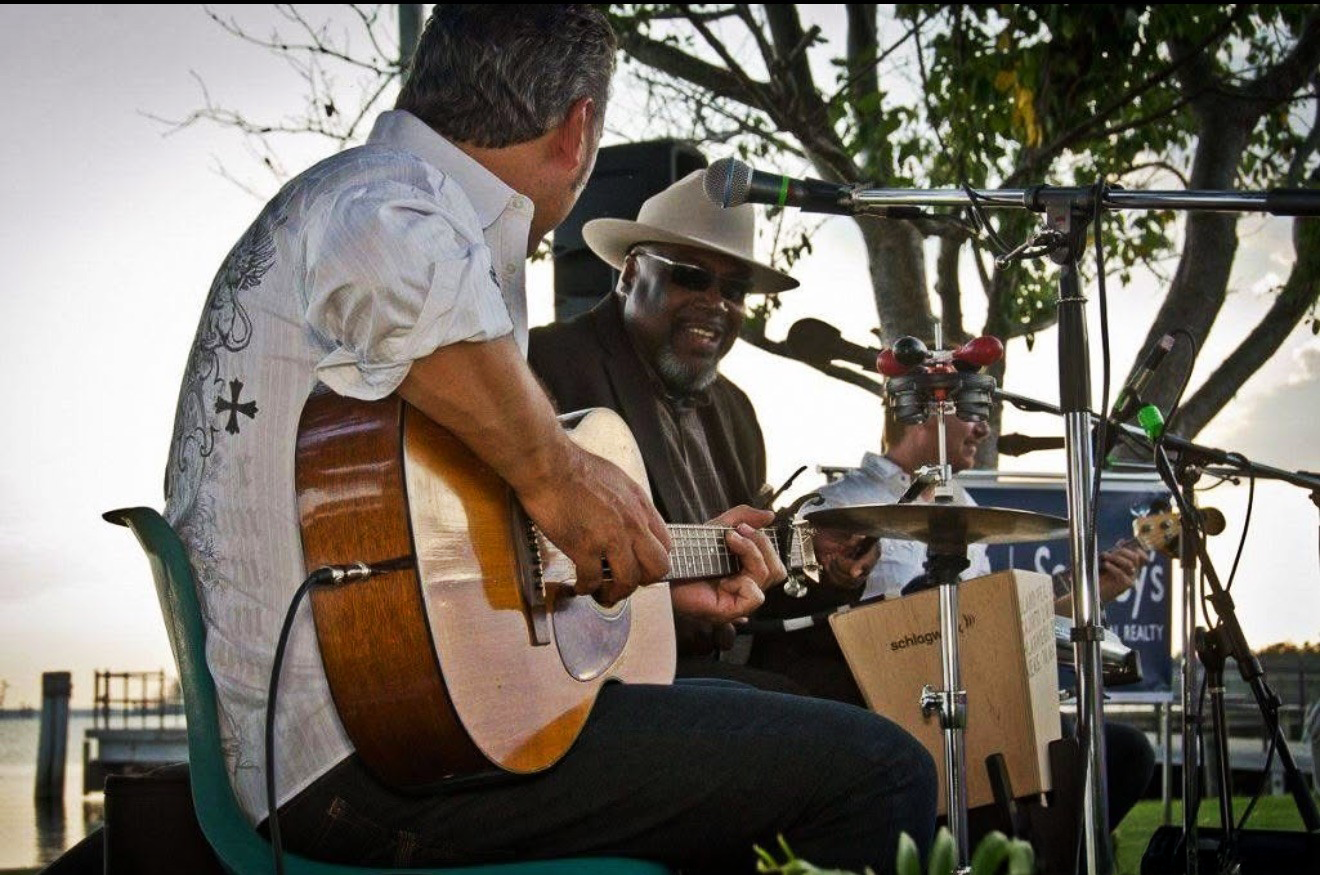 musicians performing on guitars, drums, and singing in Edenton