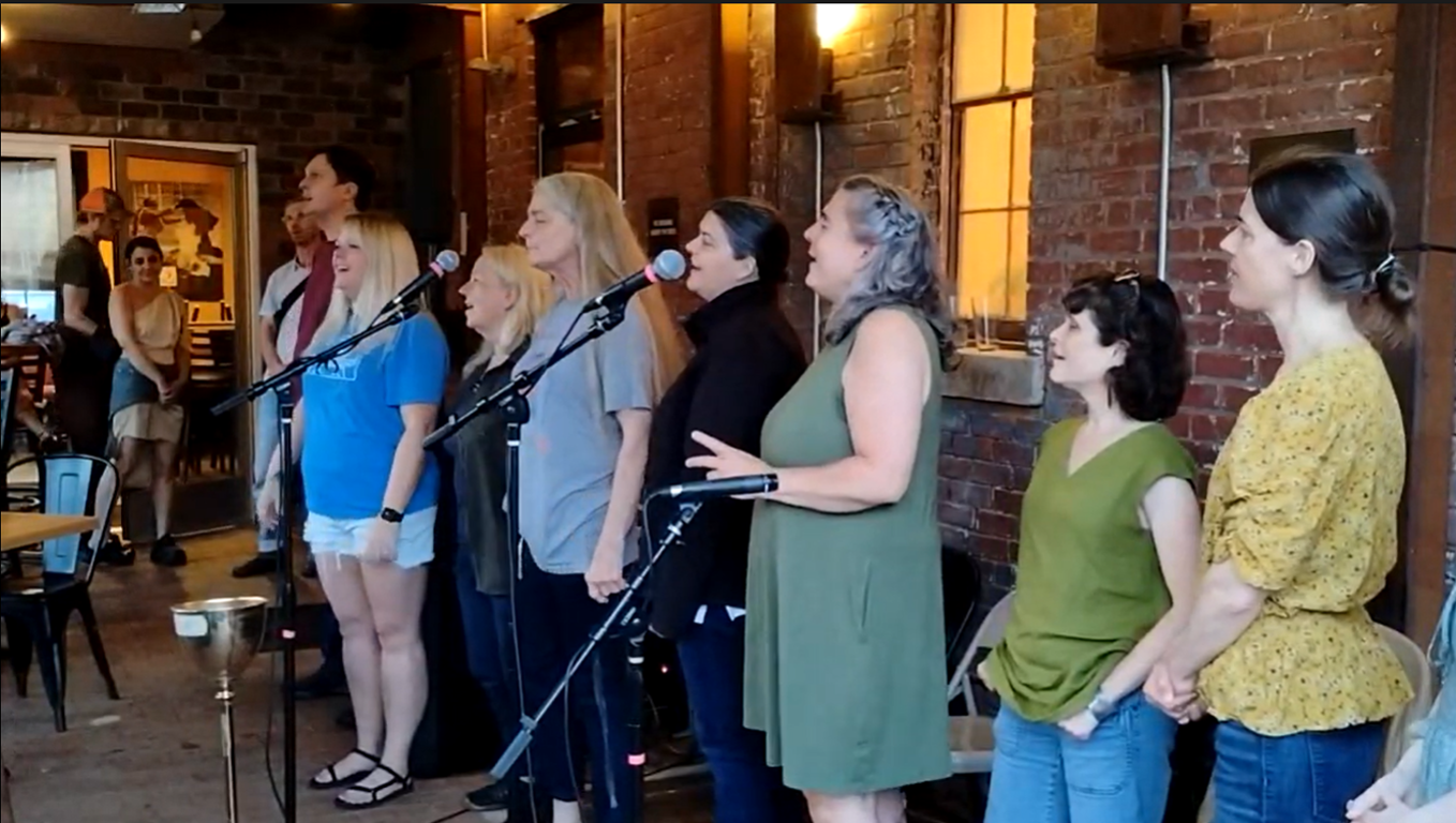 People singing at a ballad swap at the Old Marshall Jail