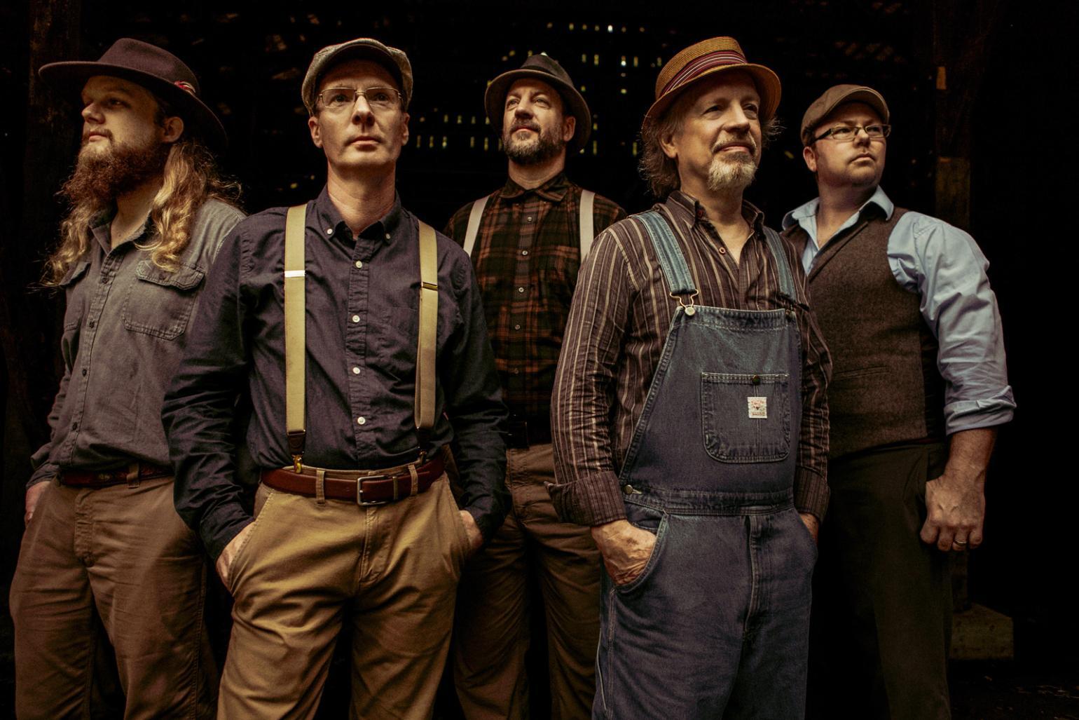 five men in old-timey outfits and hats