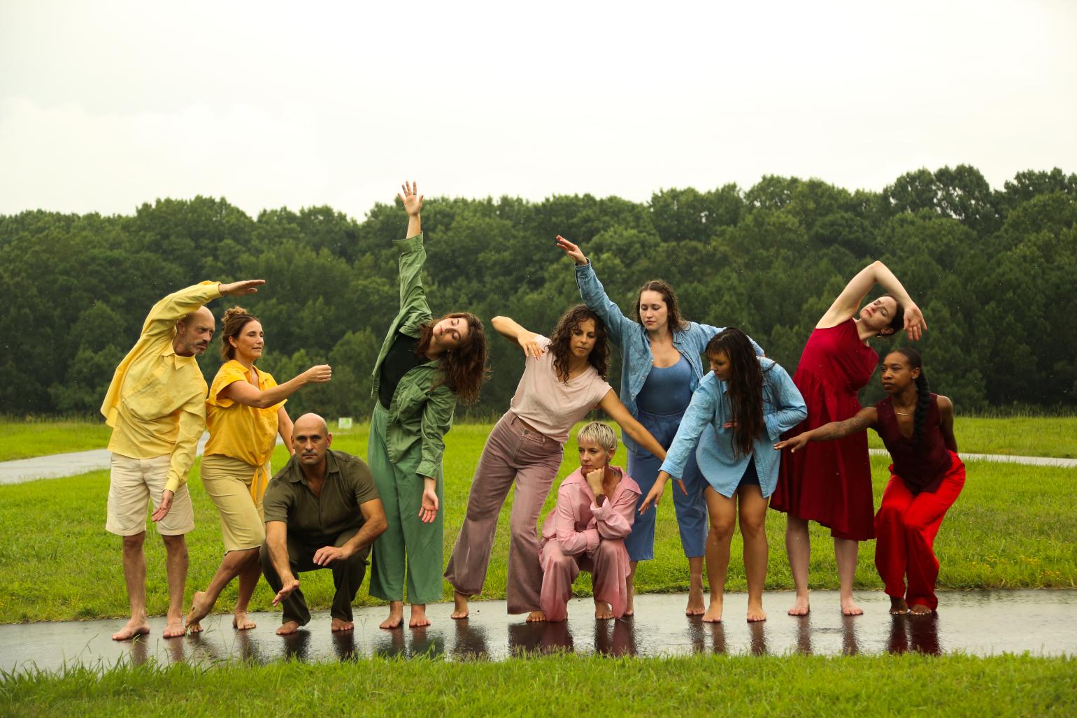 Dancers in poses outdoors, each wearing bold bright colors