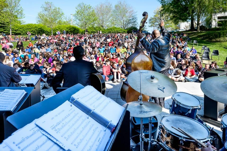 John Brown Jazz band performing in front of a group of students seated on a lawn