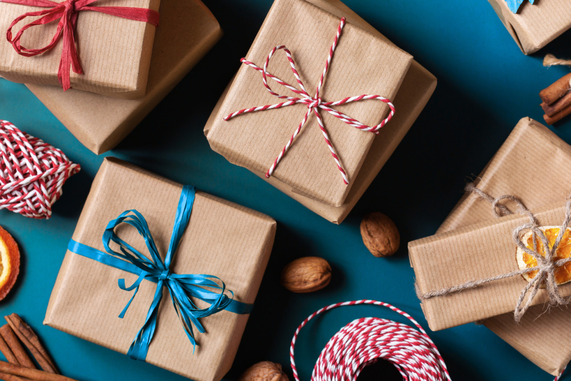 gift wrapped presents with ribbons and twine with mulling spices laying around a table