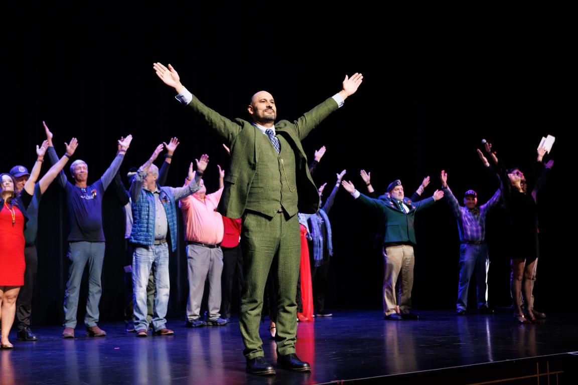 U.S. Army veteran Alfredo Hurtado leads members of Black Box Dance Theatre and Brothers and Sisters Like These in signing ‘Show Up’ at the Community First premiere of We Lift Each Other in Asheville