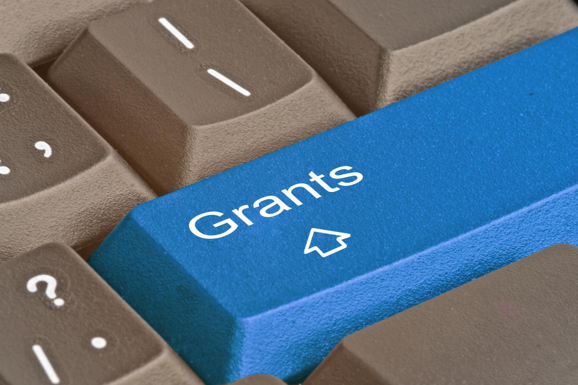 Blue keyboard key with the word Grants on it