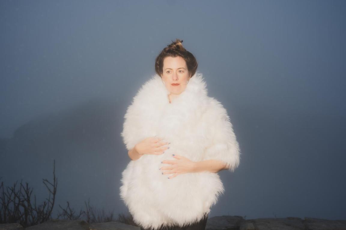 Skylar Gudasz stands for a portrait in a foggy scene